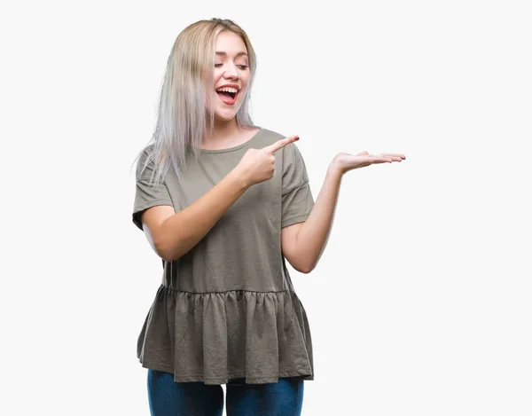 Young Blonde Woman Isolated Background Amazed Smiling Camera While Presenting — Stock Photo, Image