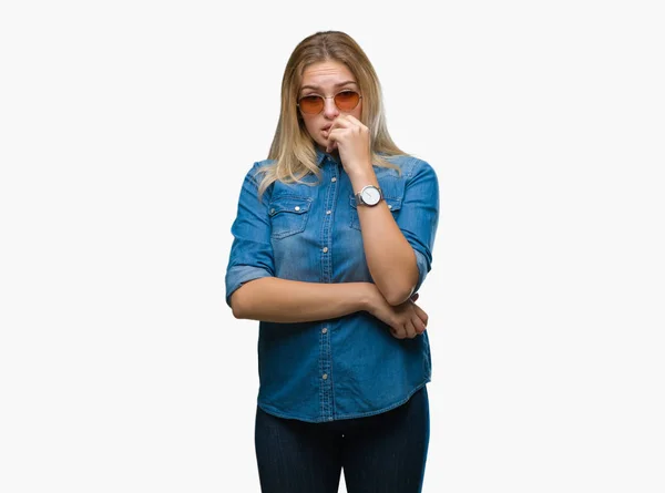 不安や 緊張を探して孤立の背景の上にサングラスをかけている若い白人女性手爪をかむ口 不安の問題 — ストック写真