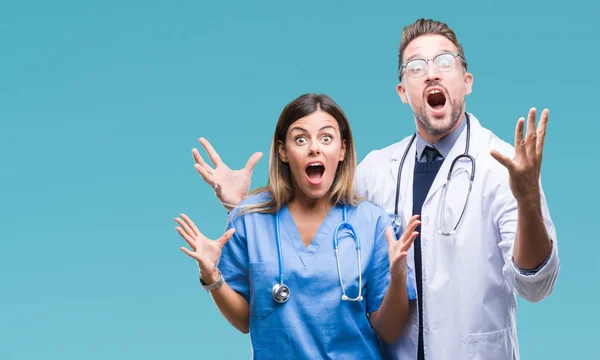 Casal Jovem Médico Cirurgião Sobre Fundo Isolado Celebrando Louco Espantado — Fotografia de Stock