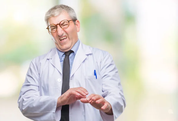 Handsome senior doctor, scientist professional man wearing white coat over isolated background disgusted expression, displeased and fearful doing disgust face because aversion reaction. With hands raised. Annoying concept.