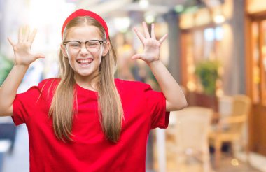 Young beautiful girl wearing glasses over isolated background showing and pointing up with fingers number ten while smiling confident and happy. clipart