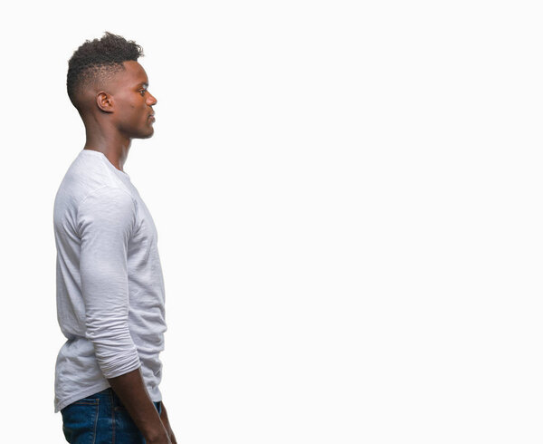 Young african american man over isolated background looking to side, relax profile pose with natural face with confident smile.