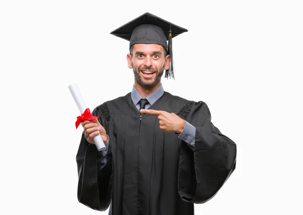 ハンサムな若い男の手と指で指している非常に幸せな孤立の背景の上の学位を保持を卒業しました — ストック写真