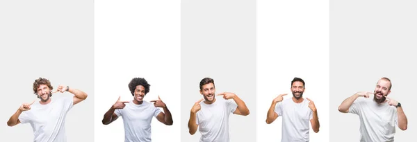 年轻的白种人 西班牙裔 非洲男人穿着白色 T恤在白色孤立的背景微笑着自信显示和指向用手指的牙齿和嘴 健康理念 — 图库照片