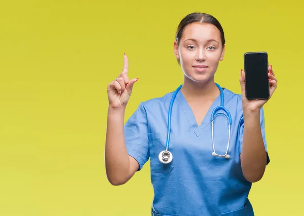 Young Caucasian Doctor Woman Showing Smarpthone Isolated Background Surprised Idea — Stock Photo, Image