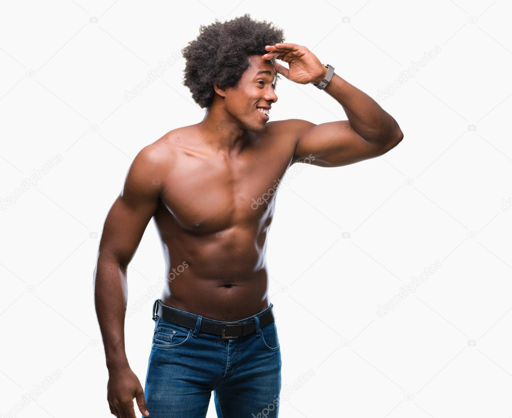 Afro american shirtless man showing nude body over isolated background very happy and smiling looking far away with hand over head. Searching concept.