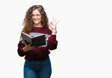 Genç esmer kız parmak, mükemmel sembolü ile ok işareti yapıyor izole arka plan üzerinde gözlük takan bir kitap okuma