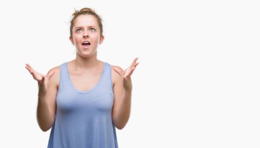 Sarışın genç kadın çılgın ve kızgın bağırarak ve agresif ifade ve silah kaldırdı bağırıyordu. Hayal kırıklığı kavramı.