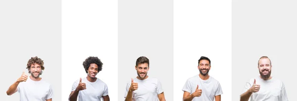 年轻的白种人 西班牙裔 非洲男人穿着白色 T恤在白色孤立的背景做快乐的大拇指与手做愉快的大拇指手势 通过显示成功来批准镜头的表达 — 图库照片