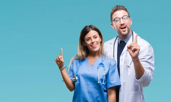 Young Couple Doctor Surgeon Isolated Background Pointing Finger Successful Idea — Stock Photo, Image