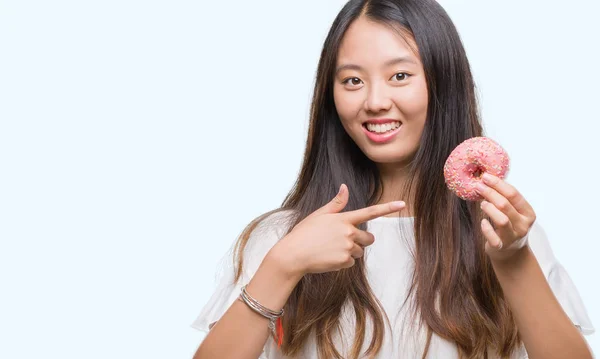 Young Asian Woman Eating Donut Isolated Background Very Happy Pointing — Stock Photo, Image