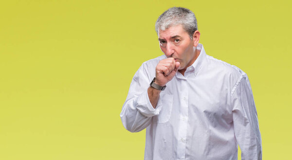 Handsome senior man over isolated background feeling unwell and coughing as symptom for cold or bronchitis. Healthcare concept.