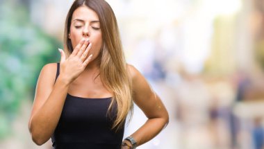 Genç güzel kadın izole arka plan üzerinde el ile ağız kapsayan yorgun esneme sıkılmış. Restless ve uyku hali.