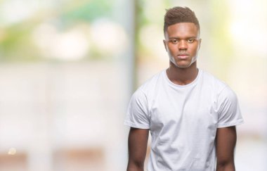 Afrikalı-Amerikalı genç yüzünde ciddi bir ifade ile izole arka plan üzerinde. Basit ve doğal kameraya bakıyor.