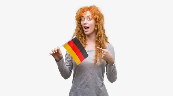 Young Redhead Woman Holding Flag Germany Very Happy Pointing Hand — Stock Photo, Image