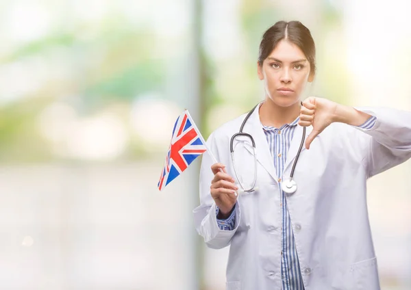 Jovem Médica Hispânica Segurando Bandeira Reino Unido Com Rosto Zangado — Fotografia de Stock