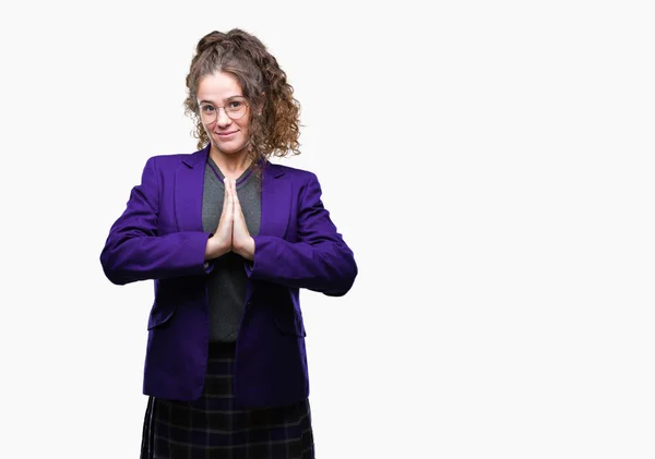 Stock image Young brunette student girl wearing school uniform and glasses over isolated background praying with hands together asking for forgiveness smiling confident.