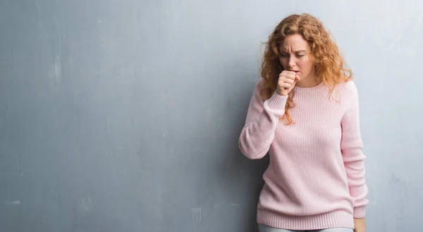 Young Redhead Woman Grey Grunge Wall Wearing Pink Sweater Feeling — Stock Photo, Image