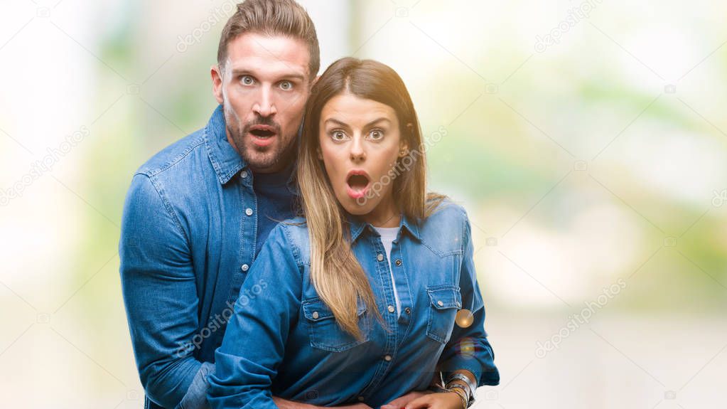 Young couple in love over isolated background afraid and shocked with surprise expression, fear and excited face.