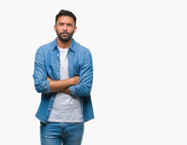 İzole arka plan şüpheci ve sinir, onaylamayan ifade yüz çapraz kolları olan yetişkin İspanyol adam. Negatif kişi.