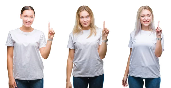 在孤立的背景下 一群年轻女性穿着白色 在微笑着自信和快乐的同时 用手指第一的手指显示出来 — 图库照片