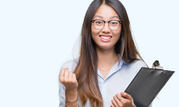 Young Asian Business Woman Holding Clipboard Isolated Background Screaming Proud — Stock Photo, Image
