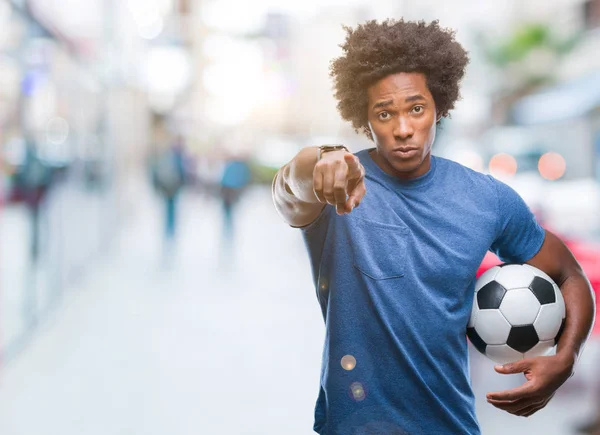 Afro American Man Trzymając Piłki Nożnej Białym Tle Wskazując Palcem — Zdjęcie stockowe