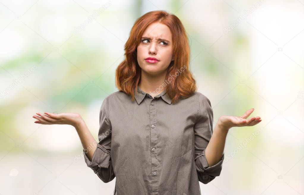 Young beautiful woman over isolated background clueless and confused expression with arms and hands raised. Doubt concept.