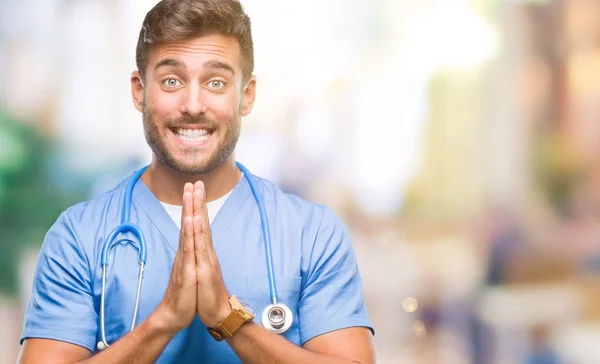 Junge Hübsche Arzt Krankenschwester Mann Über Isolierten Hintergrund Beten Mit — Stockfoto