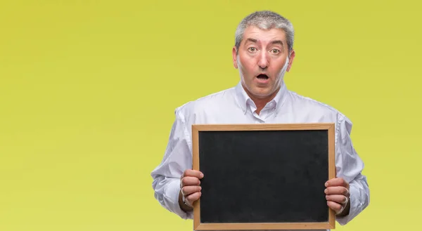 Handsome Senior Teacher Man Holding Blackboard Isolated Background Scared Shock — Stock Photo, Image