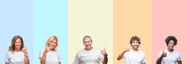 一群年轻和中年的人穿着白色的 T恤在颜色隔离的背景下用手做快乐的大拇指手势 通过显示成功来批准镜头的表达 — 图库照片