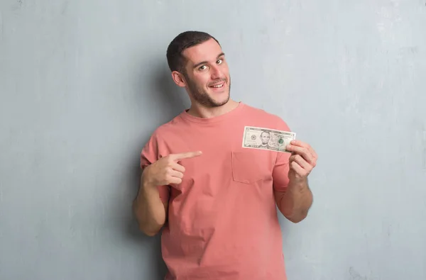 Young Caucasian Man Grey Grunge Wall Showing Five Dollars Very — Stock Photo, Image