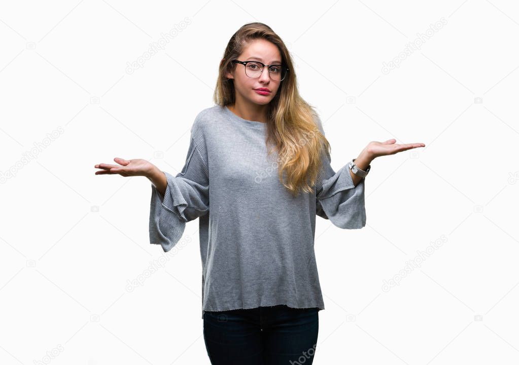 Young beautiful blonde woman wearing glasses over isolated background clueless and confused expression with arms and hands raised. Doubt concept.