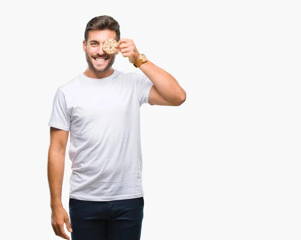 Junger Gutaussehender Mann Isst Schokoladenkekse Vor Isoliertem Hintergrund Mit Einem — Stockfoto