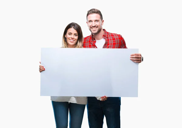 Casal Jovem Juntos Segurando Banner Branco Sobre Fundo Isolado Com — Fotografia de Stock