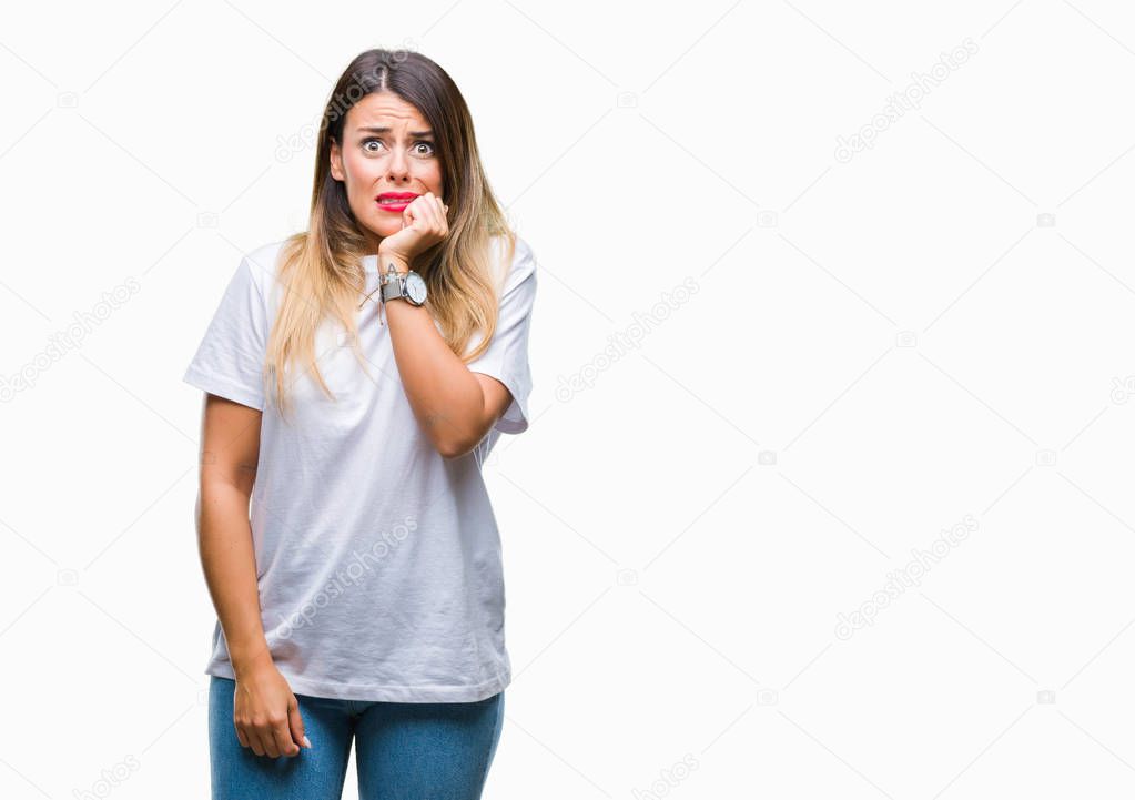 Young beautiful woman casual white t-shirt over isolated background looking stressed and nervous with hands on mouth biting nails. Anxiety problem.