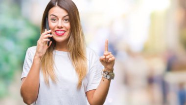 Genç güzel kadın konuşma arama üzerinden Smartphone kullanarak arka plan ile bir fikir ya da gülen yüz, bir numara ile parmak işaret soru sürpriz izole