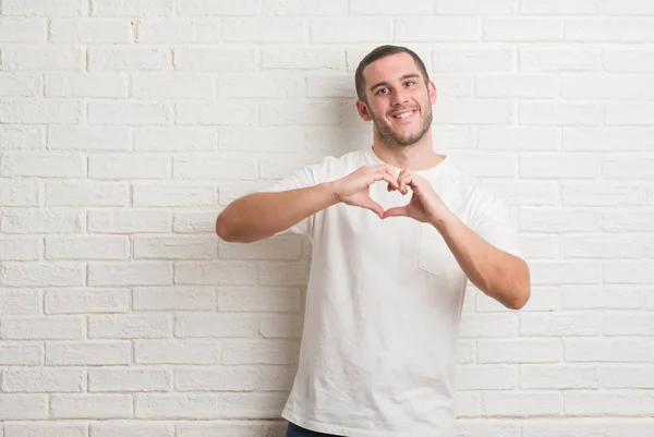 Young Caucasian Man Standing White Brick Wall Smiling Love Showing — Stock Photo, Image