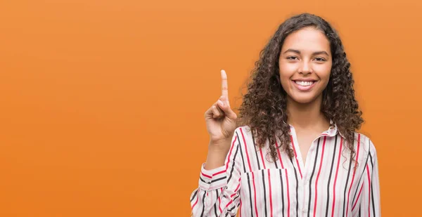 Beautiful Young Hispanic Woman Showing Pointing Finger Number One While — Stock Photo, Image