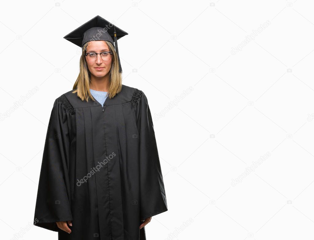 Young beautiful woman wearing graduated uniform over isolated background with serious expression on face. Simple and natural looking at the camera.