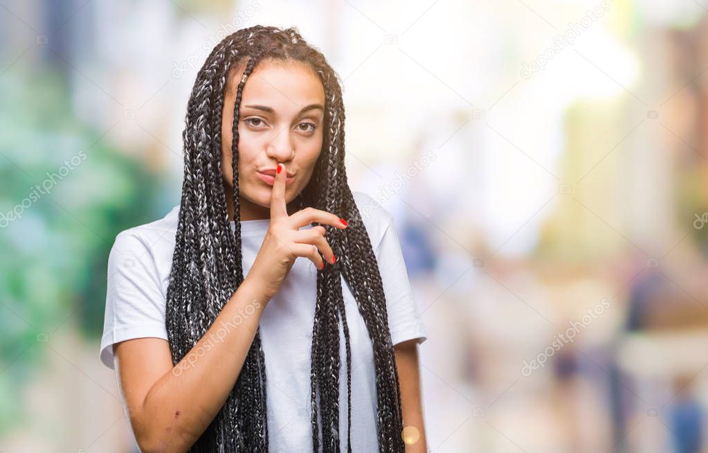 Young braided hair african american girl over isolated background asking to be quiet with finger on lips. Silence and secret concept.