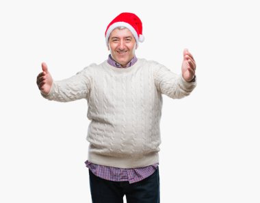 Yakışıklı komuta sizde sarılmak için kollarını açarak gülümseyerek kameraya bakarak izole arka plan üzerinde Noel şapka giyiyor. Neşeli ifade kucaklayan mutluluk.