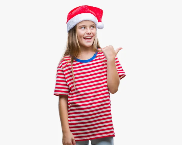 探していると親指側に上向きの幸せそうな顔を浮かべて隔離された背景にクリスマス帽子身に着けている美しい少女 — ストック写真