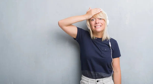 Mujer Caucásica Adulta Sobre Pared Gris Grunge Usando Auriculares Estresados —  Fotos de Stock