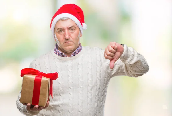 Handsome Senior Man Wearing Christmas Hat Holding Gift Isolated Background — Stock Photo, Image