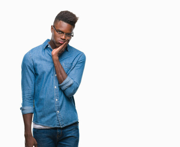 Young african american man over isolated background thinking looking tired and bored with depression problems with crossed arms.