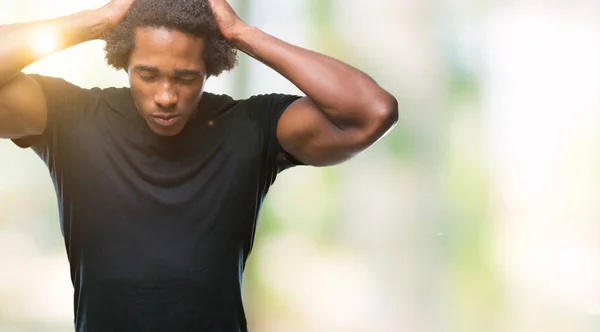Afro american man over isolated background suffering from headache desperate and stressed because pain and migraine. Hands on head.