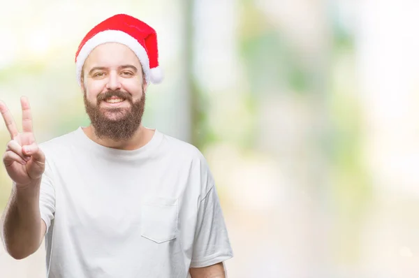 Young Caucasian Hipster Man Wearing Christmas Hat Isolated Background Smiling — Stock Photo, Image