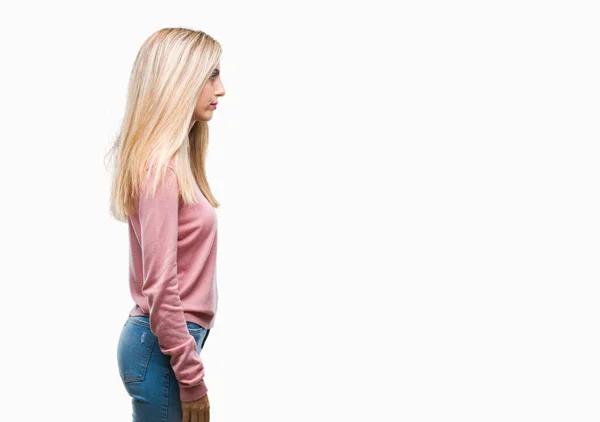 年轻美丽的金发女子穿着粉红色的冬季毛衣在孤立的背景寻找侧 放松的轮廓姿势与自然脸与自信的微笑 — 图库照片