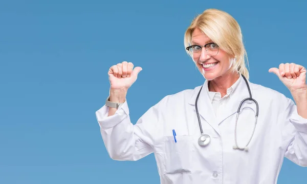 Middle age blonde doctor woman over isolated background looking confident with smile on face, pointing oneself with fingers proud and happy.